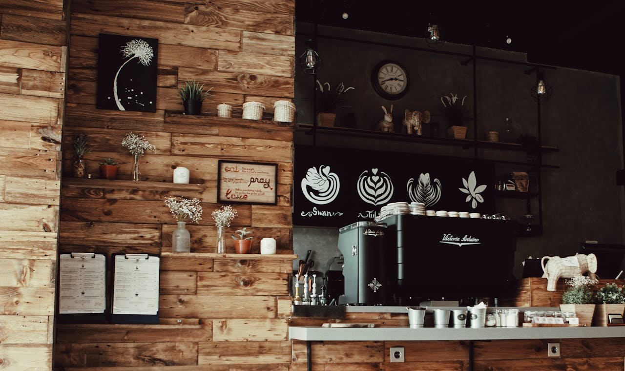 Warm rustic coffee shop interior featuring a wooden decor and a professional espresso machine.